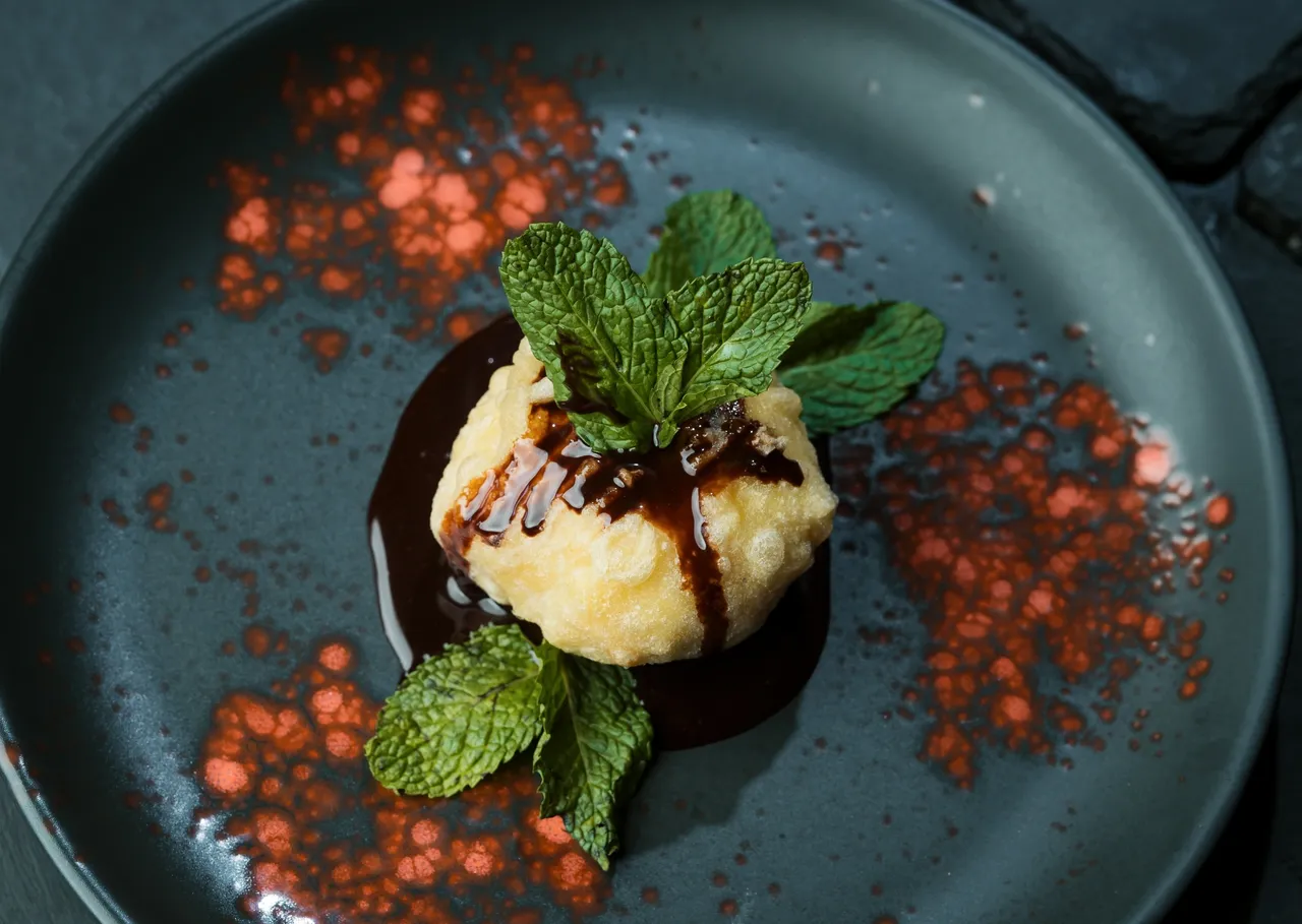 Dining 1 a plate of food with mint leaves and chocolate sauce