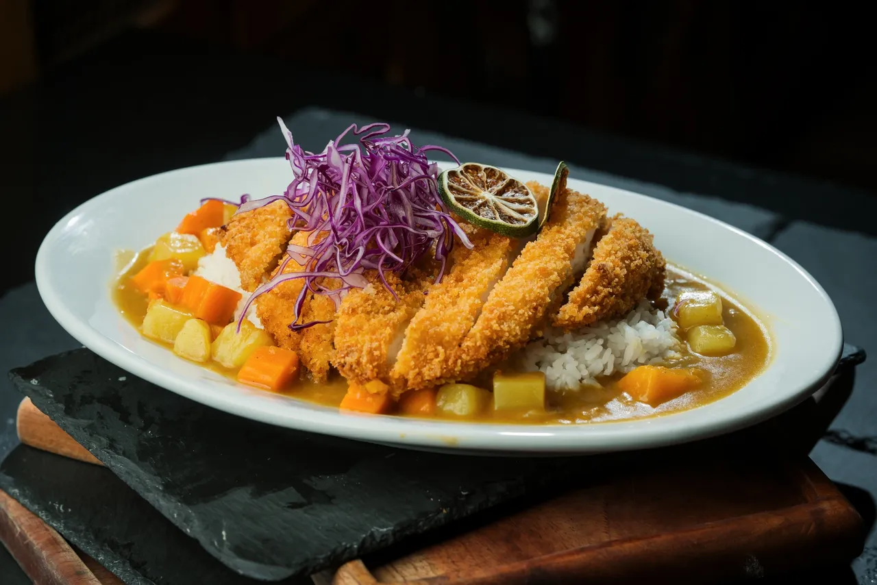 Dining 3 a plate of food on a black surface
