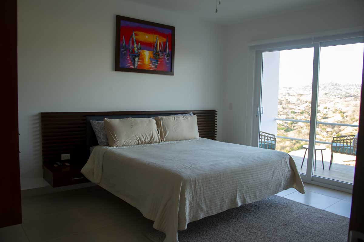 3 Bedroom Mountain View Villas 4 a bed with a bed frame and a painting on the wall - Villa at Malibu