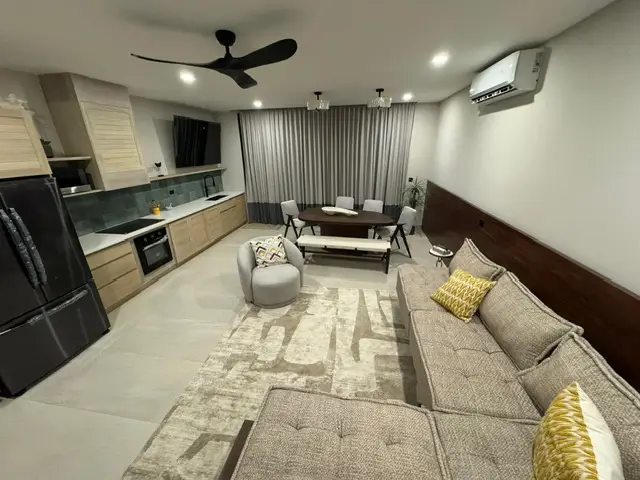 3 Bedroom Ocean View Sunset Villas 8 a living room with a couch and a table